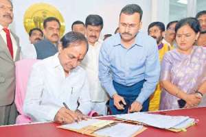 On his first day in his new chamber, CM KCR signs six files.