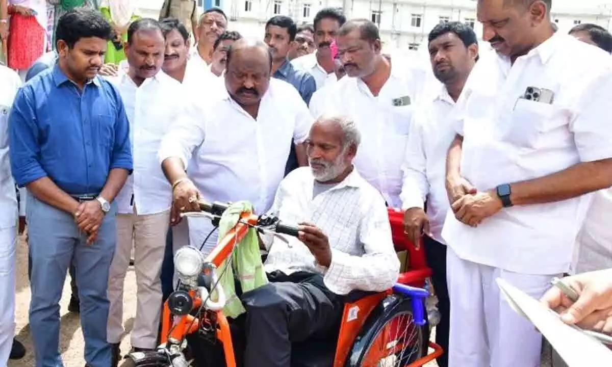 Disabled individuals receive tricycles from Gangula in Karimnagar.