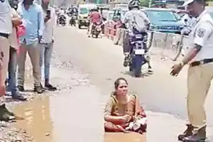 Protestor in Nagole Sits on Pothole to Demand Better Roads