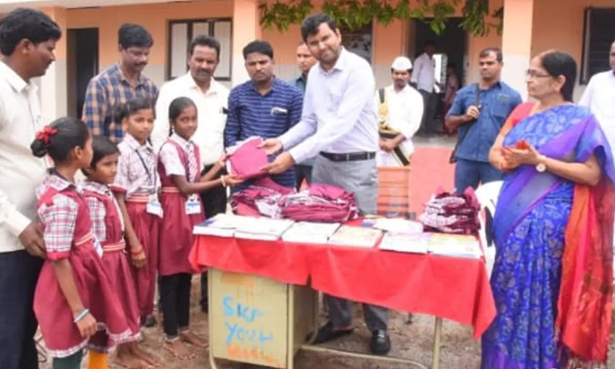 Santhosh of D C BM distributes uniforms to school children