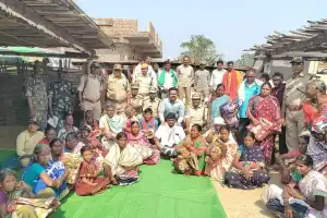 Forest officer hands out blankets to tribal families