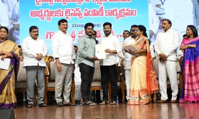 Chief Minister Revanth Reddy gives licenses to land surveyors in Telangana